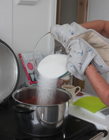 Adding sugar to the jam